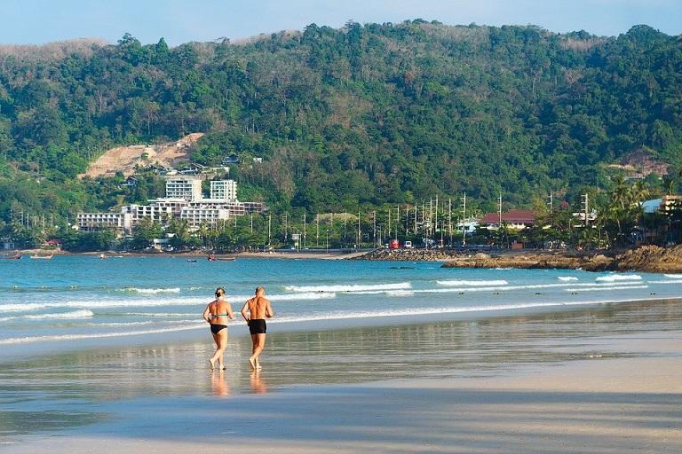 image of people running on beach
