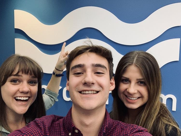 three interns in front of WordStream logo