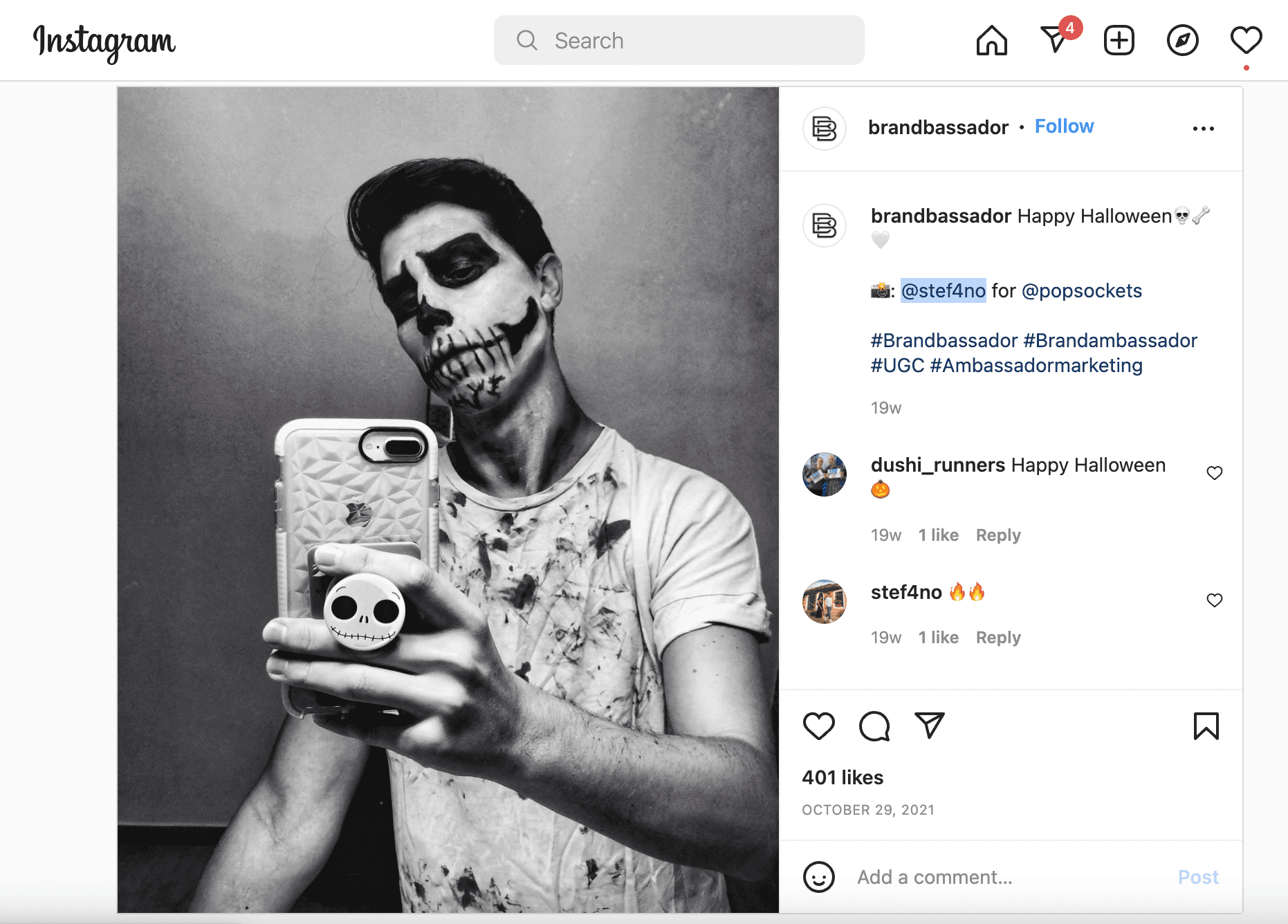 A screenshot Popsockets’ Emoji Outfit Challenge Instagram post. The image features a man with Halloween skull makeup, holding a phone with a skull Popsockets design, corresponding to the skull emoji.