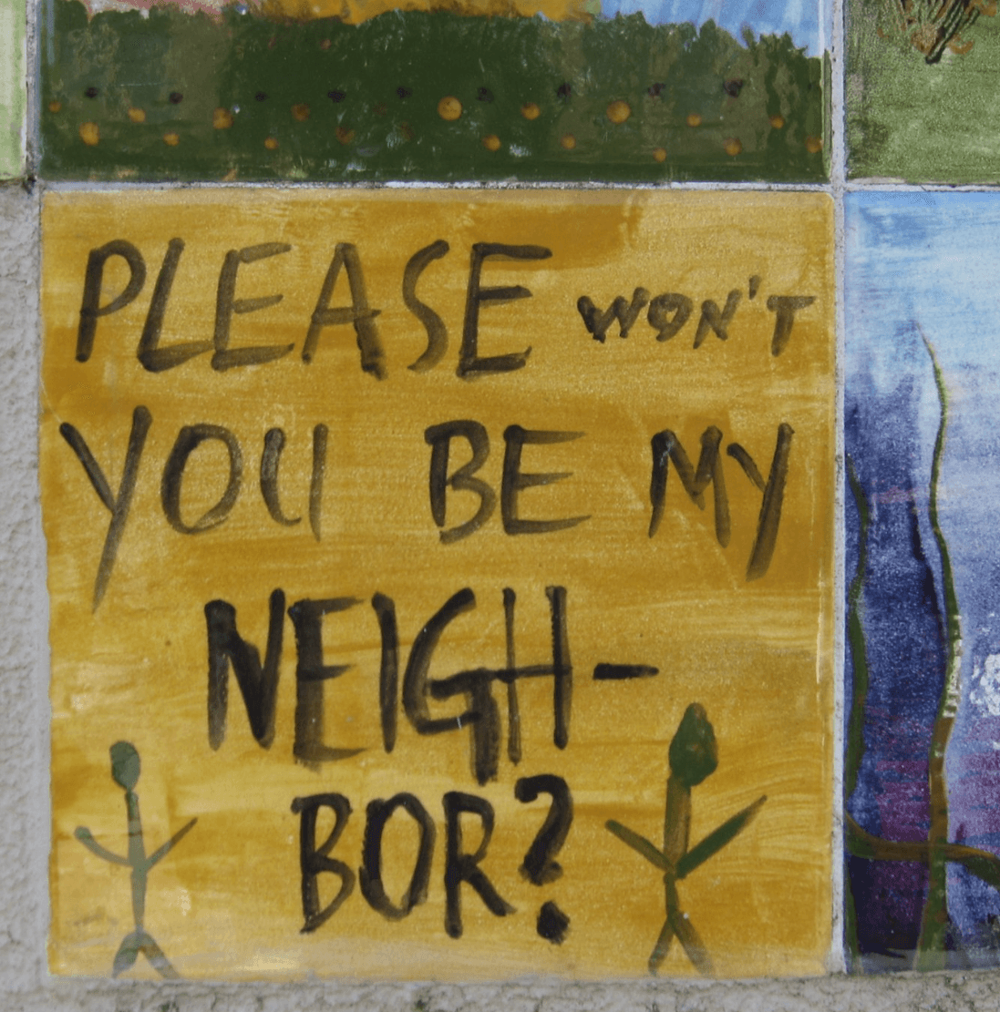 Photo of handwritten sign reading "Please won't you be my neighbor?"